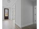Bright entryway featuring light gray plank floors and a dark stained front door at 747 Maynard Ln, Summerville, SC 29486