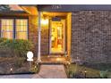 Inviting front entrance with decorative lights, well-maintained landscaping and brick facade at 7753 Linsley Dr, North Charleston, SC 29418