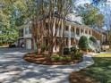 Stunning home with a circular driveway, a three-car garage, and lush landscaping at 8608 Wild Bird Ct, North Charleston, SC 29420