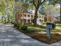 Well-maintained home featuring manicured landscaping, a long driveway, and a charming mailbox at 8608 Wild Bird Ct, North Charleston, SC 29420