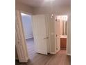 Bedroom with hardwood flooring and two closet doors, leading to a bathroom at 9044 Greenbriar Dr, Summerville, SC 29485