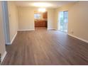 Spacious living room featuring hardwood flooring and a sliding glass door to backyard at 9044 Greenbriar Dr, Summerville, SC 29485