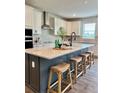 Modern kitchen featuring white cabinets, stainless steel appliances, a large island and counter seating at 1001 Middleton Dr Dr, Goose Creek, SC 29445