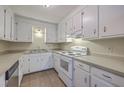 Functional kitchen featuring white cabinets, a stainless steel dishwasher, and an electric stove at 106 Mayrant St, Summerville, SC 29483
