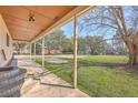 Inviting covered porch with a view of the expansive front yard and mature trees at 106 Mayrant St, Summerville, SC 29483
