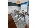 A well-lit dining room with modern decor, including a wooden table, gray chairs, and a stylish area rug at 107 Hainsworth Dr, North Charleston, SC 29418