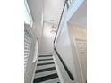 An interior view of a staircase with black steps and railing, leading up to the second floor at 107 Hainsworth Dr, North Charleston, SC 29418
