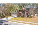 Beautiful two-story brick home with a well-manicured lawn and mature trees at 1104 Old Course Ln, Mount Pleasant, SC 29466