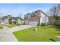 Well-maintained two-story home featuring a two-car garage and a spacious driveway at 1114 Donerail Ln, Johns Island, SC 29455