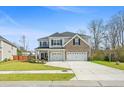 Two-story home with a two-car garage and an inviting landscaped front yard at 1114 Donerail Ln, Johns Island, SC 29455
