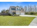 Beautiful two-story home featuring a well-kept lawn and a spacious two-car garage at 1114 Donerail Ln, Johns Island, SC 29455