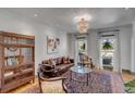 Bright living room featuring a leather sofa, stylish rug, and ample natural light from large windows at 1228 Penny Cir, Mount Pleasant, SC 29464