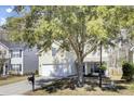 Charming two-story home with a driveway, green lawn, and mature landscaping at 126 Moon Shadow Ln, Summerville, SC 29485