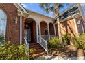 Lovely brick home featuring a white columned front porch and well-maintained landscaping at 1407 Congressional Blvd, Summerville, SC 29483