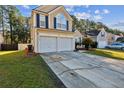 Two-story home with a two-car garage, spacious driveway, and neatly landscaped front yard at 1452 Water Edge Dr, Charleston, SC 29492