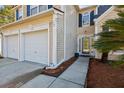 Close-up view of a charming home's entrance, showcasing the two-car garage and beautifully landscaped walkway at 1452 Water Edge Dr, Charleston, SC 29492