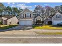 Inviting two-story home with a two-car garage and well-maintained front lawn in a friendly neighborhood at 1452 Water Edge Dr, Charleston, SC 29492