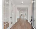 Light-filled hallway with hardwood floors and stylish white doors at 1640 Siloh Siloh Dr # 477, Mount Pleasant, SC 29466
