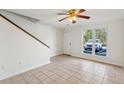 Bright living room with neutral tile flooring, a ceiling fan and a staircase at 1735 Boone Hall Dr # K14, Charleston, SC 29407