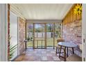 Enclosed patio with brick accent wall, wood-look floors, and views of the backyard at 1836 Mepkin Rd # D4, Charleston, SC 29407