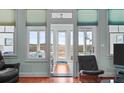 Bright living area boasting ample natural light with expansive windows offering marsh views at 1902 Long Bend Dr # 1B, Seabrook Island, SC 29455