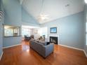 Bright living room with hardwood floors, vaulted ceilings, fireplace, and open dining area at 2009 Arundel Pl, Mount Pleasant, SC 29464