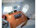 Living room with wood floors, fireplace, vaulted ceilings, and abundant natural light at 2009 Arundel Pl, Mount Pleasant, SC 29464