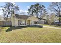 Inviting single-story home with a well-maintained front yard and long driveway under a blue sky at 203 Birmingham Dr, Summerville, SC 29486
