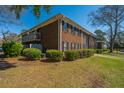 Brick apartment building includes a balcony and view of the parking lot at 21 Rivers Point Row Row # 17 B, Charleston, SC 29412