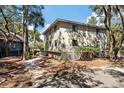 Side view of condo with a wooden walkway and lush surroundings at 214 Sea Cloud Cir, Edisto Island, SC 29438
