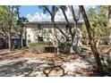 Condo building exterior with a view of private balconies, trees, and shaded parking at 214 Sea Cloud Cir, Edisto Island, SC 29438