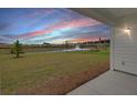 Back porch with a view of the landscaped backyard, waterway, and neighborhood beyond at 220 Garden Gate Way, Summerville, SC 29486