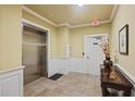 Hallway with elevator, stairs, tile flooring, and decorative table and accessories at 2244 Ashley Crossing Dr # 1236, Charleston, SC 29414