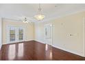 Bright living room with hardwood floors, ceiling fan, and access to a balcony with natural light at 2244 Ashley Crossing Dr # 1236, Charleston, SC 29414