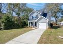 Well-manicured lawn leads to this beautiful home featuring gray siding and an attached garage at 2280 Bailey Dr, Charleston, SC 29405