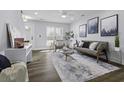 Inviting living room featuring modern décor, a ceiling fan, and natural light from the front door at 2280 Bailey Dr, Charleston, SC 29405