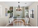 Cozy dining room showcasing a wooden table with white chairs and stylish light fixture at 2508 Melville Rd, North Charleston, SC 29406