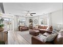 Bright living room with hardwood floors, ceiling fan, and comfortable leather seating at 2508 Melville Rd, North Charleston, SC 29406