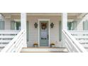 Inviting front porch features a sage door, seasonal decor, and stairs at 3554 Clambank Dr, Mount Pleasant, SC 29466