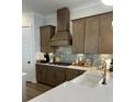 Stylish kitchen featuring stainless steel appliances, custom cabinetry, and elegant backsplash at 365 Trailmore Ln, Summerville, SC 29486