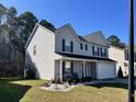 View of a well-kept two-story home with a two-car garage and manicured landscaping at 415 Aberdeen Cir, Summerville, SC 29483