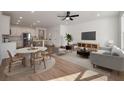 Bright open-concept living space with hardwood floors, modern furniture, and a stylish kitchen at 416 Duskywing Dr, Goose Creek, SC 29445