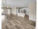 Bright, open-concept living area features a spacious floor plan, kitchen with white cabinets, and lots of natural light at 431 Eva St, Moncks Corner, SC 29461