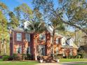 Beautiful brick house with dormers, a front yard, a driveway, and mature trees providing shade and curb appeal at 4312 Club Course Dr, North Charleston, SC 29420