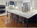 Bright, eat-in kitchen with stainless steel appliances, a large island, stylish countertops, and hardwood floors at 4312 Club Course Dr, North Charleston, SC 29420