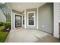 Covered porch features a welcoming entrance and view of the professionally landscaped yard at 523 Eastern Isle Ave, Summerville, SC 29486
