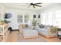 Bright and airy living room features large windows, modern furnishings, and hardwood floors at 5273 Potomac St, North Charleston, SC 29405