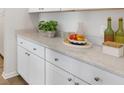 Close-up of the kitchen countertop with white cabinets, decorative plants, fruit, and accent pieces at 550 Richfield Way, Summerville, SC 29486