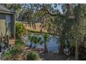 Scenic backyard view featuring a serene pond, lush greenery, and a golf course at 601 Magnolia Ln, Edisto Island, SC 29438