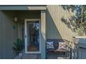 Inviting front porch with seating, stylish pillows and decor next to the front door at 601 Magnolia Ln, Edisto Island, SC 29438